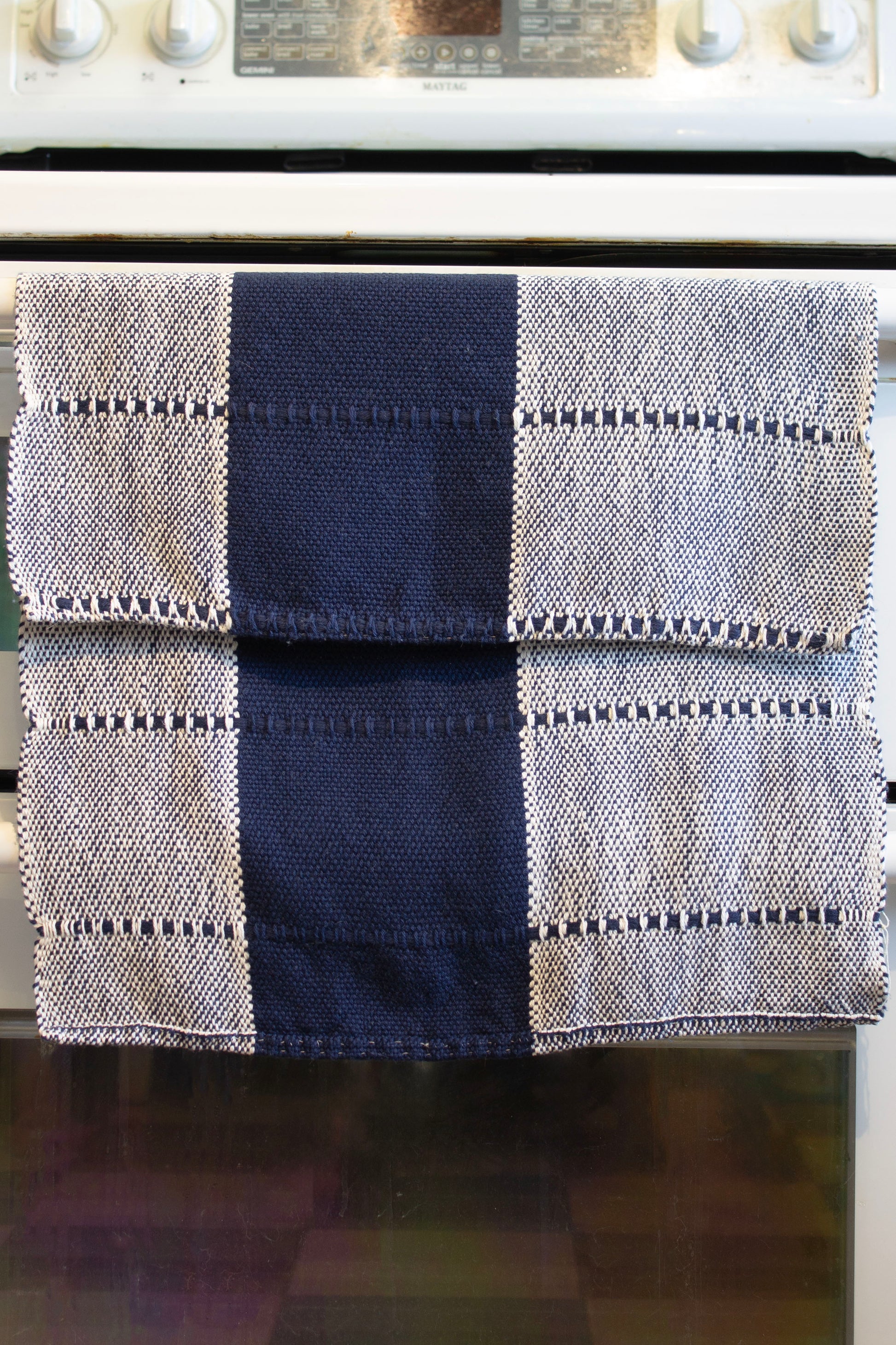 Cotton dish towel, striped navy blue, natural white, undyed, handmade, natural fibres, locally sourced yarn, washer and dryer safe, absorbent, soft, lightweight, hemstitched, hemmed, hand sewn hem